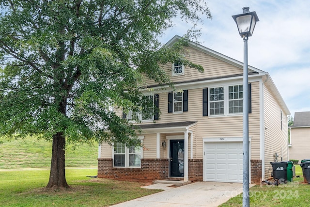 view of front of house featuring a front yard and a garage