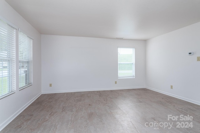 unfurnished room with light wood-type flooring