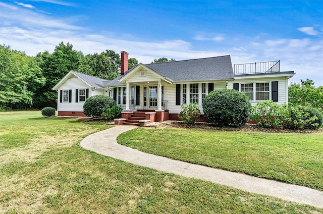 ranch-style house featuring a front lawn and covered porch