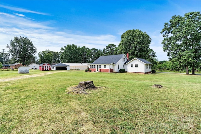 view of yard with a fire pit and a storage unit