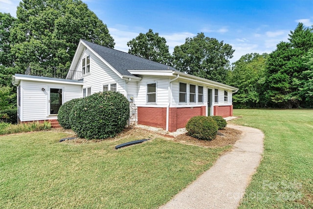 view of side of property with a lawn