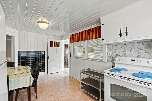 kitchen with white cabinetry and white range with electric cooktop