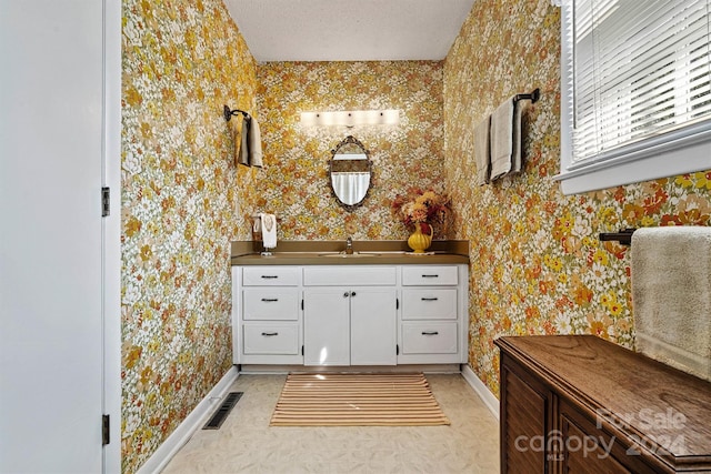 bathroom with vanity and a textured ceiling