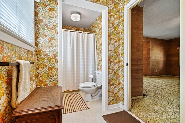 bathroom featuring toilet and a textured ceiling