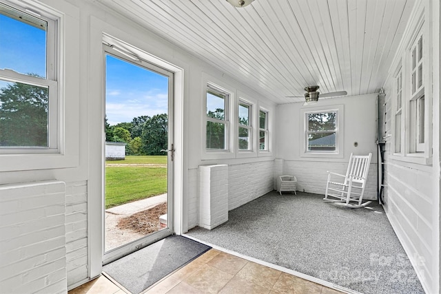 unfurnished sunroom with wooden ceiling and a healthy amount of sunlight