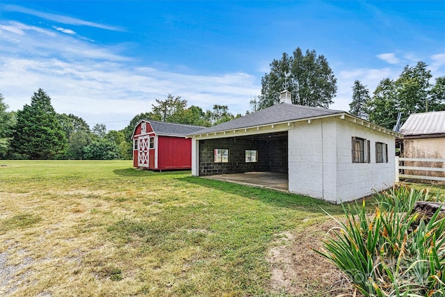 view of yard with a patio and a storage shed