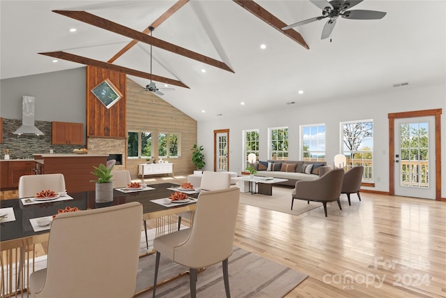 dining room with ceiling fan, beamed ceiling, light hardwood / wood-style flooring, and high vaulted ceiling