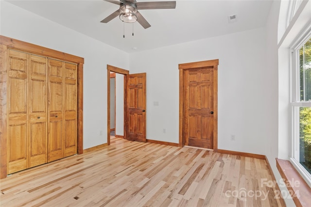 unfurnished bedroom featuring light hardwood / wood-style flooring, a closet, and ceiling fan