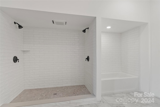 bathroom featuring separate shower and tub