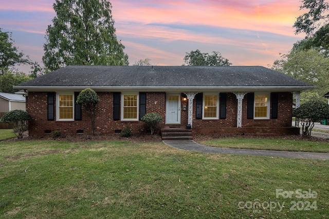 ranch-style house featuring a lawn