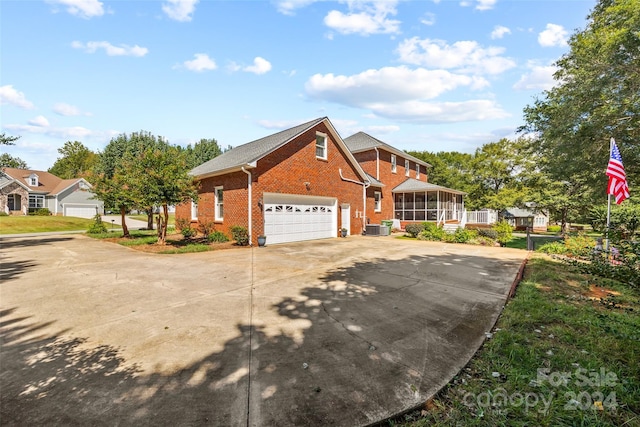 view of front of home featuring central AC and a garage