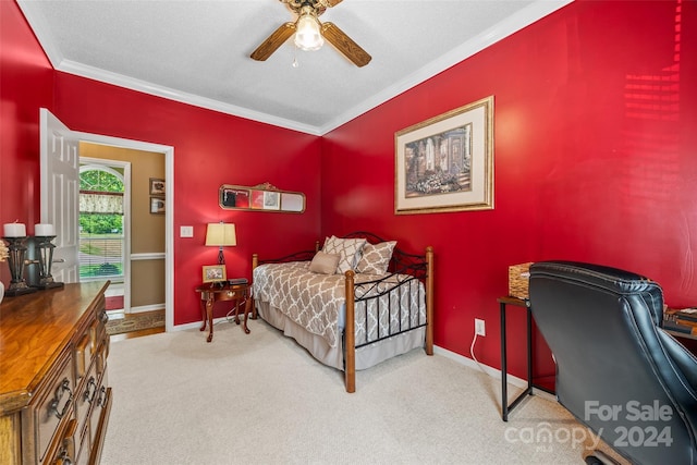 bedroom featuring ceiling fan, light colored carpet, a textured ceiling, and ornamental molding