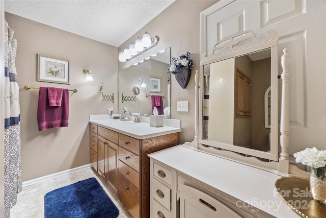 bathroom featuring a textured ceiling and vanity