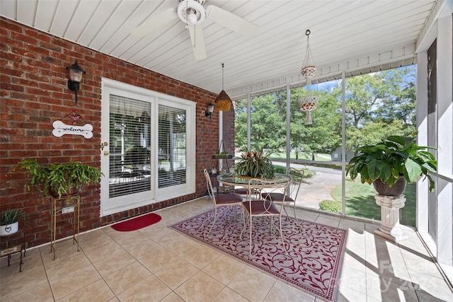 sunroom / solarium featuring wood ceiling and ceiling fan