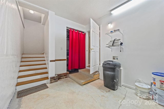 entryway with concrete flooring and a textured ceiling