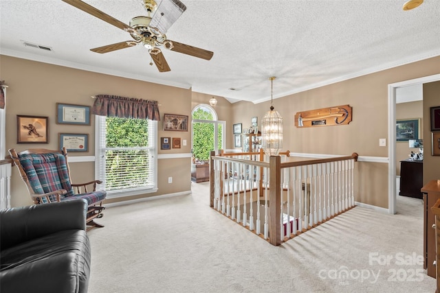 interior space with crown molding, light colored carpet, a chandelier, and a textured ceiling