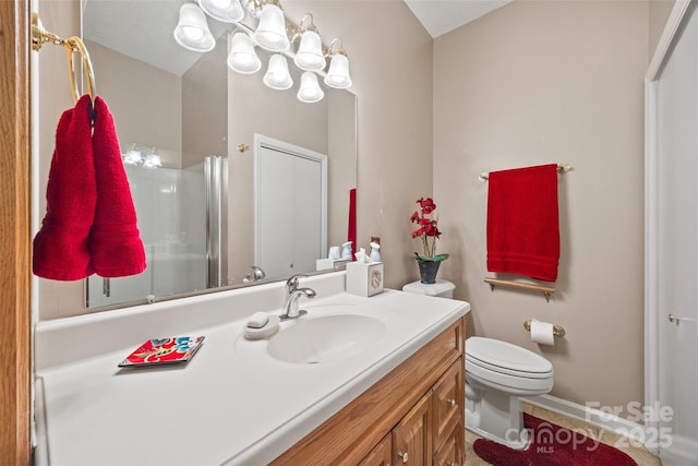 bathroom featuring vanity, toilet, a chandelier, and walk in shower