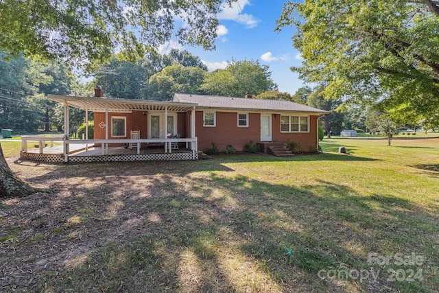 view of front facade with a front lawn and a deck