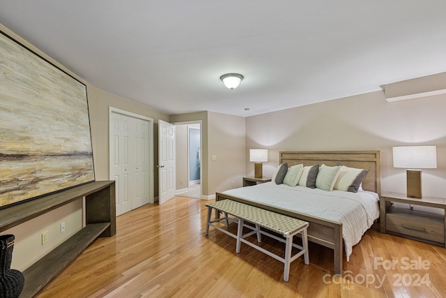 bedroom with a closet and light hardwood / wood-style floors