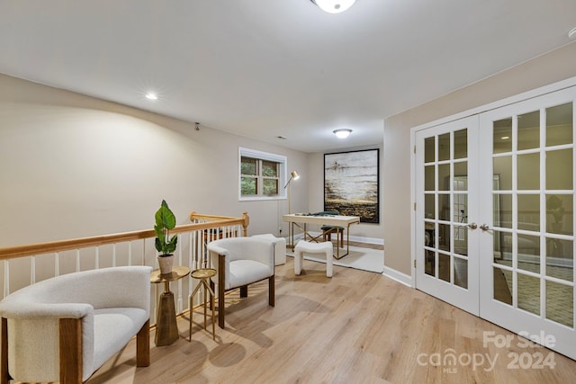 sitting room featuring light hardwood / wood-style flooring and french doors