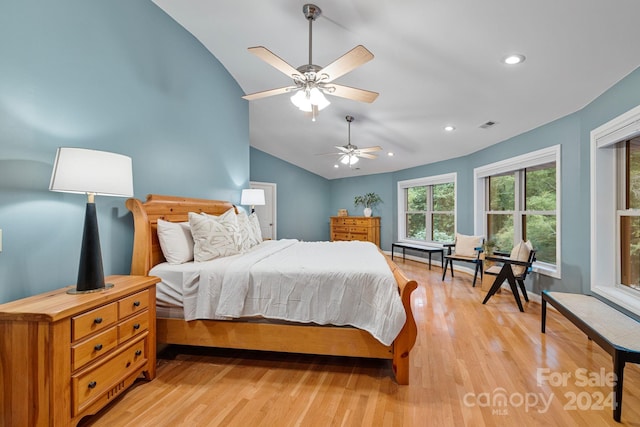 bedroom featuring vaulted ceiling, light hardwood / wood-style floors, and ceiling fan