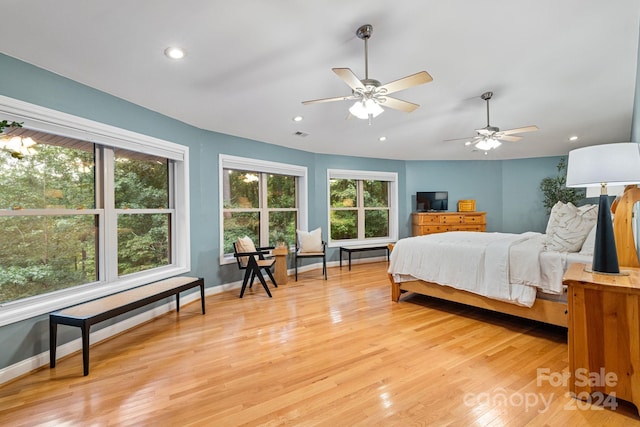 bedroom with ceiling fan and light wood-type flooring