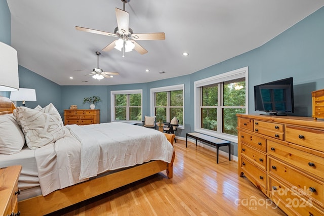 bedroom with light hardwood / wood-style floors and ceiling fan