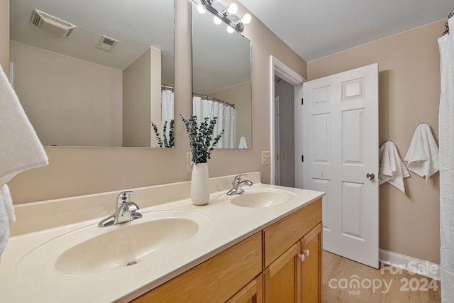 bathroom featuring vanity and hardwood / wood-style floors