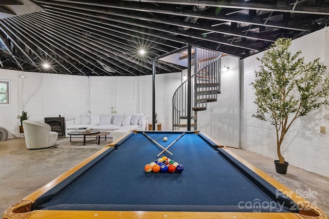 recreation room with pool table, lofted ceiling, and a wood stove