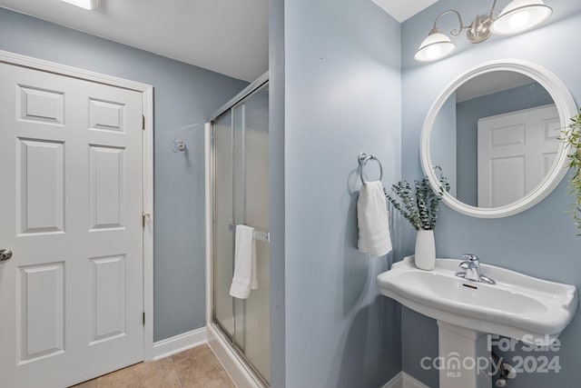 bathroom featuring tile patterned floors and an enclosed shower