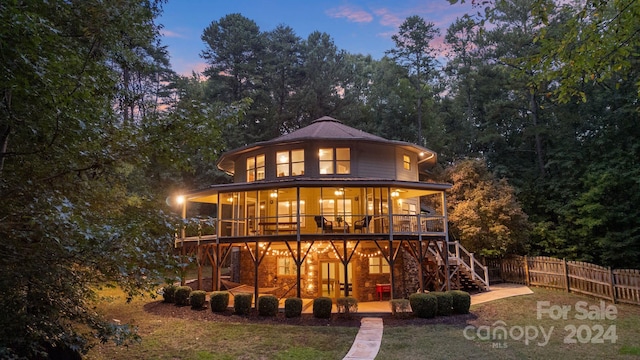 view of back house at dusk