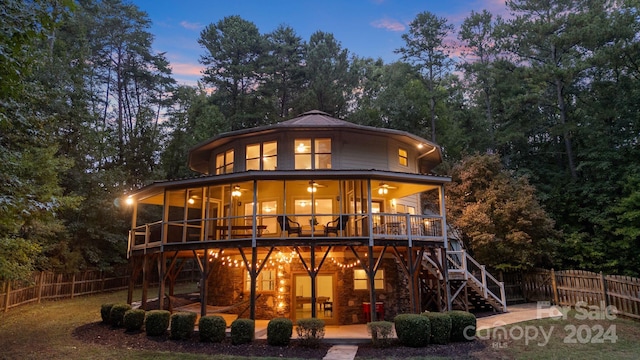 back house at dusk with a patio