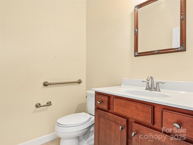 bathroom featuring vanity, tile patterned flooring, and toilet