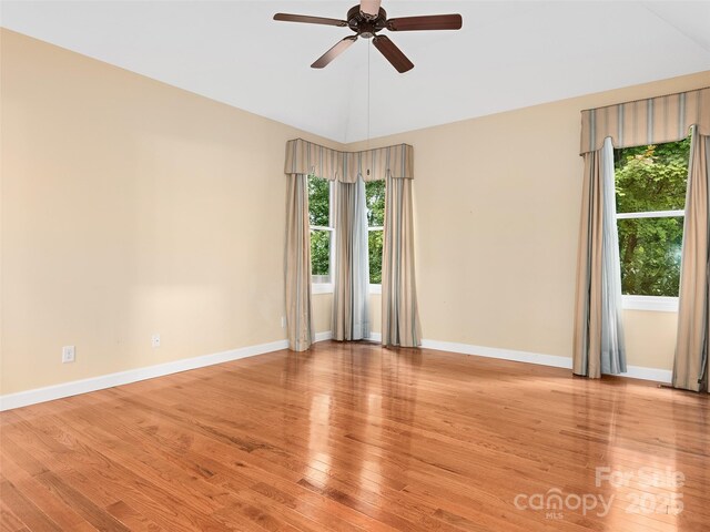 unfurnished room with lofted ceiling, ceiling fan, and light wood-type flooring