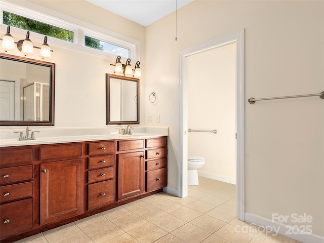 bathroom featuring vanity, a shower with shower door, tile patterned floors, and toilet