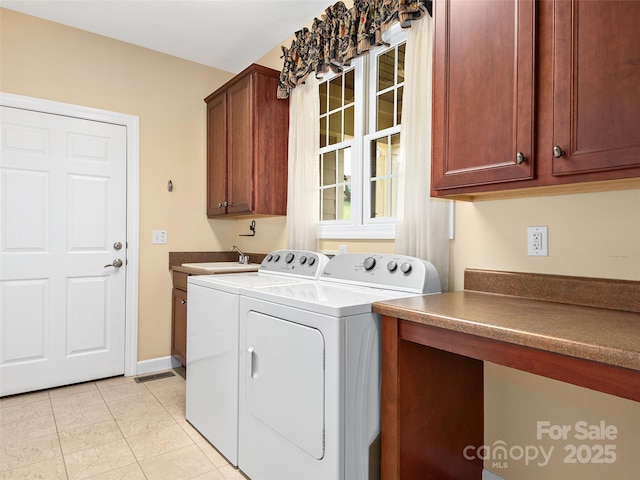 laundry area with cabinets, separate washer and dryer, sink, and light tile patterned floors