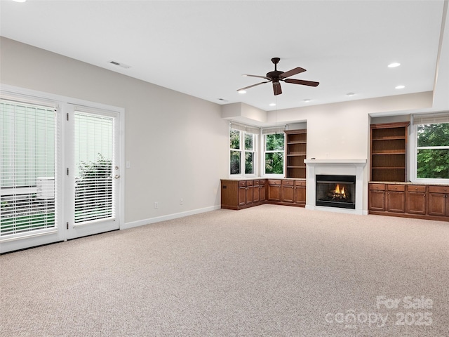 unfurnished living room featuring carpet floors and ceiling fan