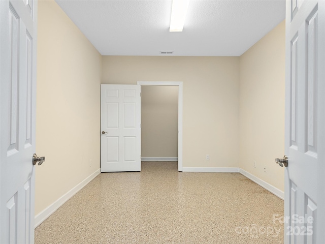 spare room featuring a textured ceiling