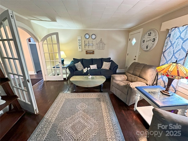 living room with french doors, ornamental molding, and dark hardwood / wood-style flooring