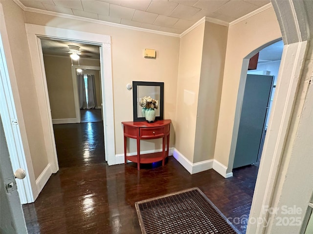 hall with ornamental molding and dark hardwood / wood-style floors