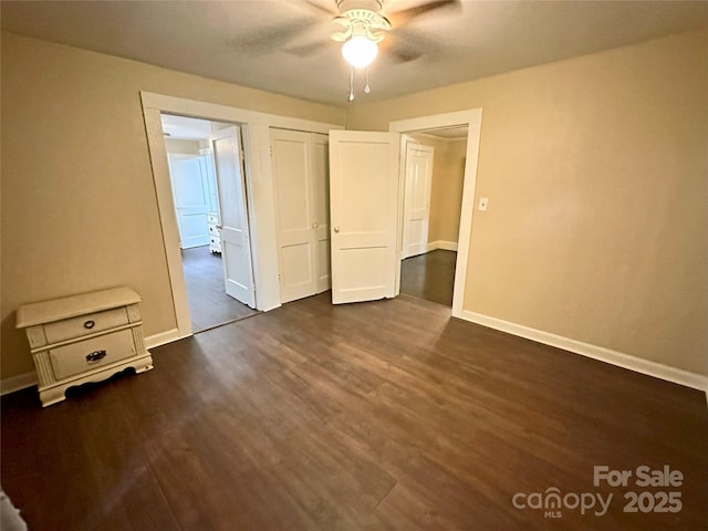 unfurnished bedroom featuring dark wood-type flooring, ceiling fan, and a closet