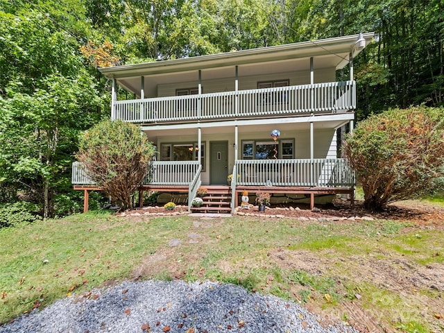 view of property with a balcony and a porch