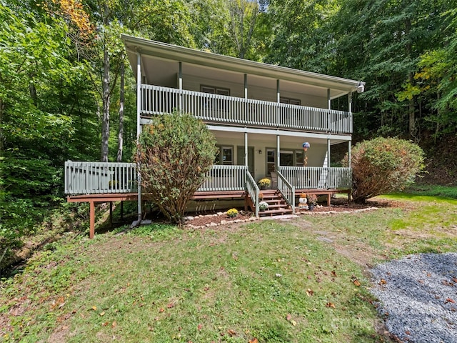 view of front facade with a balcony and a front yard