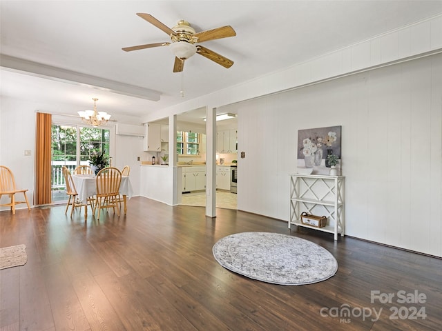 interior space featuring sink, ceiling fan with notable chandelier, and dark wood-type flooring