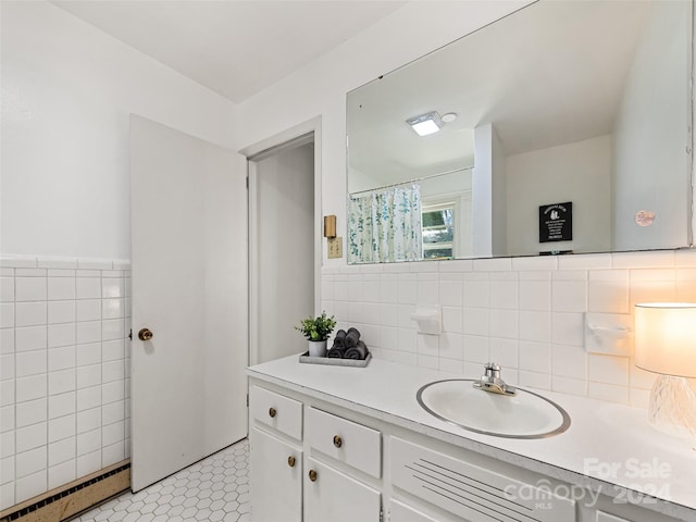 bathroom with vanity, a baseboard heating unit, tile walls, tile patterned flooring, and a shower with shower curtain