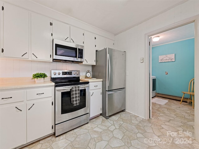 kitchen with white cabinetry, appliances with stainless steel finishes, and crown molding