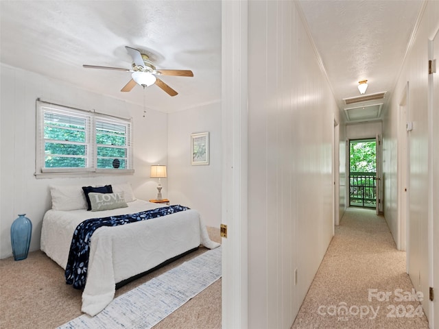 bedroom featuring ceiling fan, light colored carpet, and multiple windows