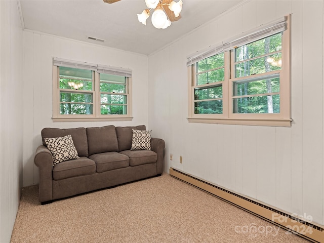 carpeted living room with a baseboard radiator, ceiling fan, and ornamental molding