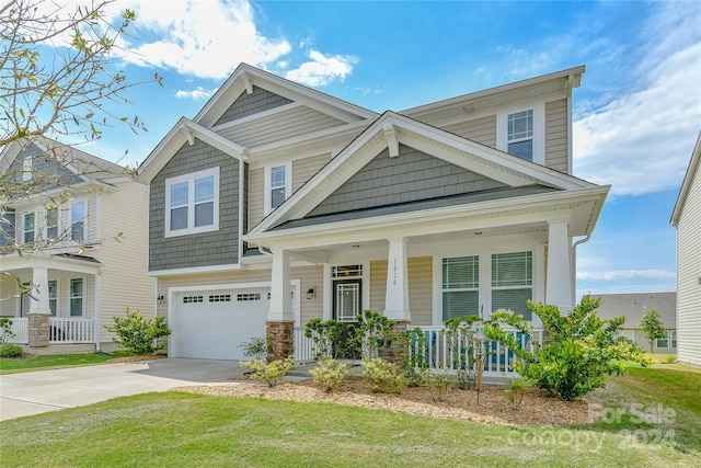 view of front of house featuring a front lawn, a porch, and a garage