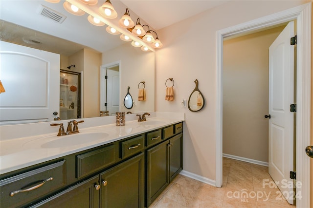 bathroom featuring vanity, an enclosed shower, and tile patterned floors